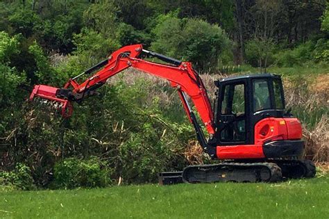 excavator with bush hog attachment